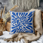 Close-up of blue faux suede throw pillow showing abstract botanical artwork and premium fabric texture.
