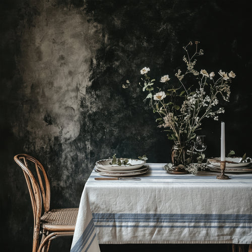 French Riviera Heritage Stripe Tablecloth featuring elegant blue stripes on 100% cotton twill, styled with ceramics and dried florals in a Mediterranean-inspired dining setting.