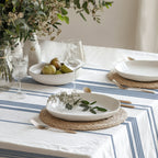Elegant blue stripe table linen styled with handmade ceramic plates, dried flowers, and natural décor for a timeless European tablescape.