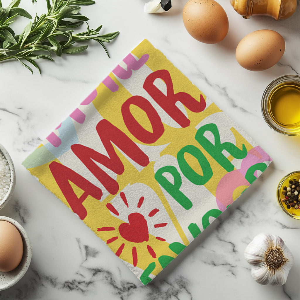 Close-up detail of the colourful one-sided print on the More Amore Por Favour kitchen tea towel, highlighting the bright lettering and graphic shapes.