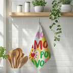 Decorative cotton twill tea towel with the More Amore Por Favour slogan, retro-style lettering and colourful heart shapes, ideal for playful kitchen styling.