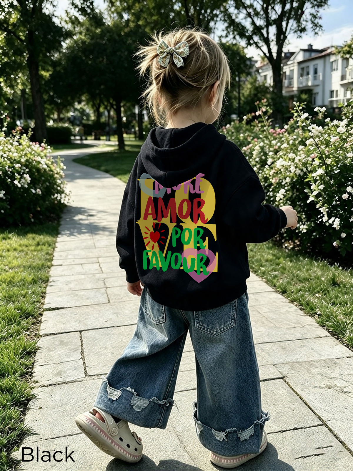 Side profile view of More Amore Por Favor toddler pullover hoodie, relaxed fit, colourful heart front, warm fleece fabric