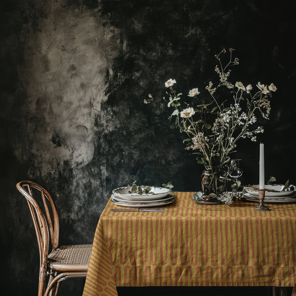 Mustard terracotta cotton twill tablecloth styled on dining table with artisan hand drawn repeat pattern