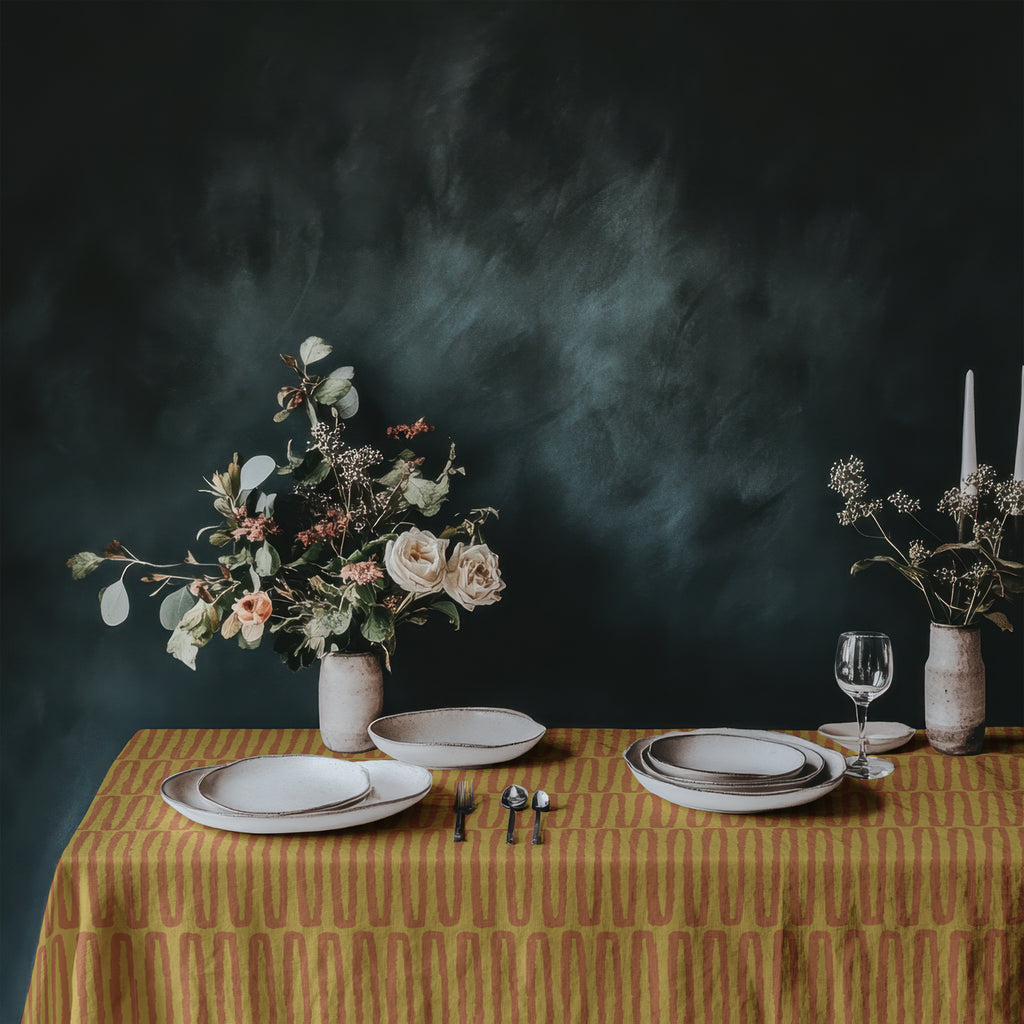 Artisan cotton dining tablecloth featuring warm mustard tones and contemporary repeat design