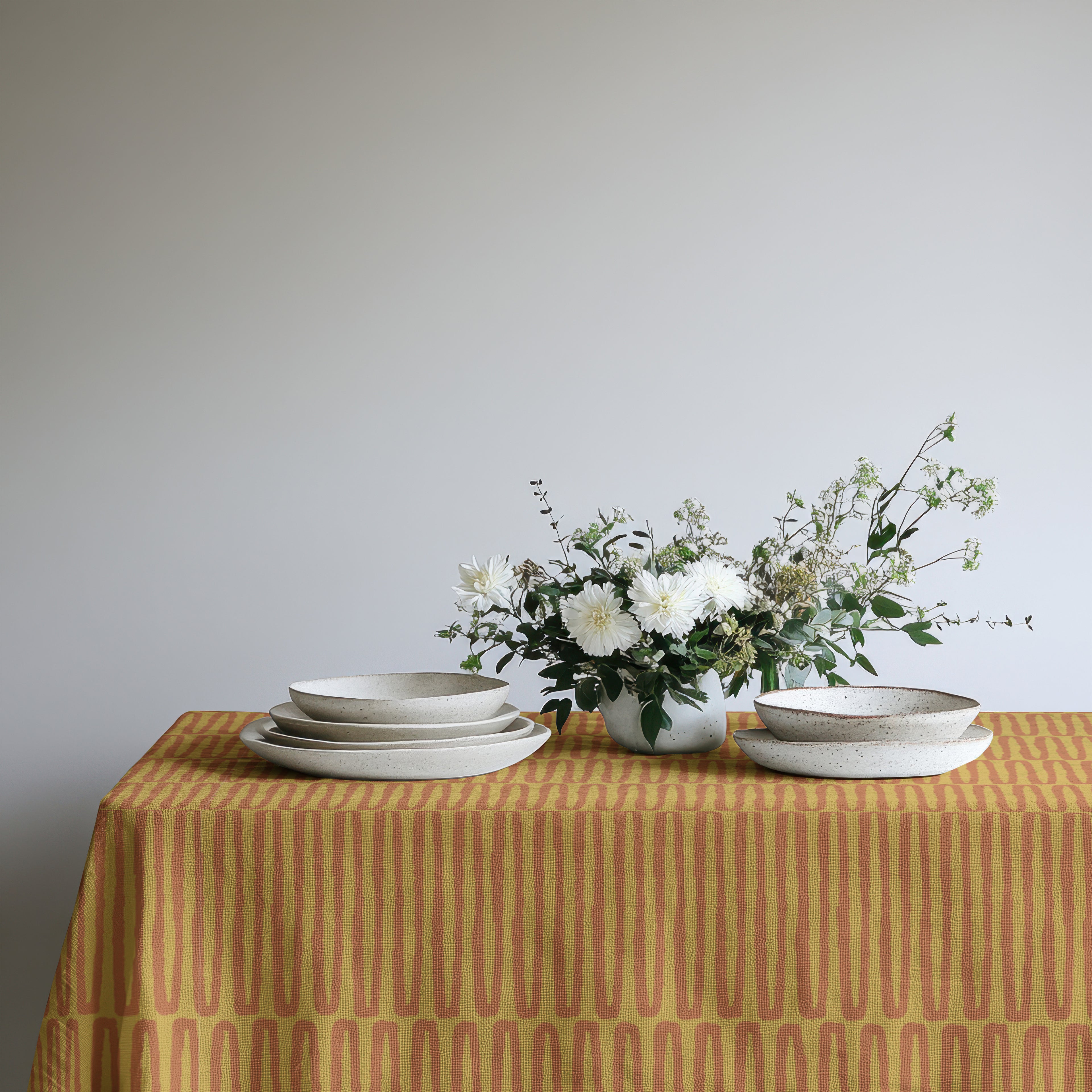 Modern farmhouse cotton tablecloth styled with candles, glassware and floral centrepiece