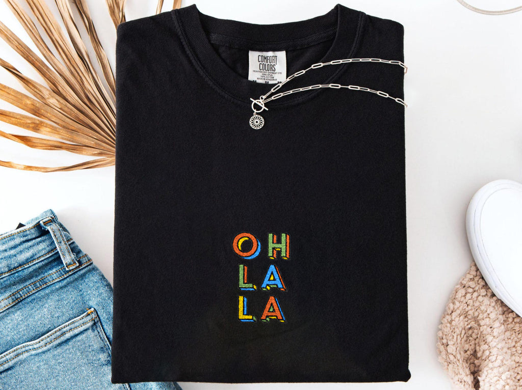 Black Oh La La embroidered boho t-shirt for women, handmade artisanal tee, casual Instagram-ready outfit, eco-friendly Comfort Colors 1717 cotton, free-spirited style