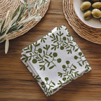 Close-up view of olive branch pattern cotton napkin showing detailed hand drawn botanical design and soft twill fabric texture