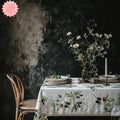 Elegant olive branch tablecloth set on a minimalist dining table with modern decor and tableware
