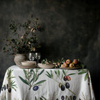 Mediterranean Olive Branch Tablecloth - Soft cotton twill featuring hand-painted olive branch illustrations. The fresh, natural pattern complements a minimalistic dining table with neutral tones.