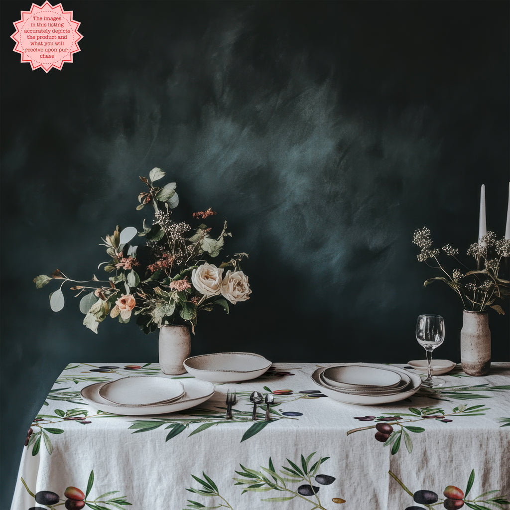 Detailed close-up view of the olive print on a natural linen tablecloth, featuring rich green olives and olive branches.