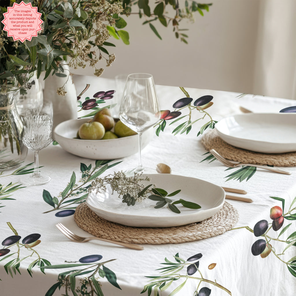 Olive branch design tablecloth laid on a dark-toned table, creating a cozy Mediterranean dining setting.