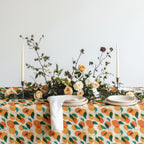 Orange pattern tablecloth styled for casual entertaining with modern Mediterranean home décor accents.