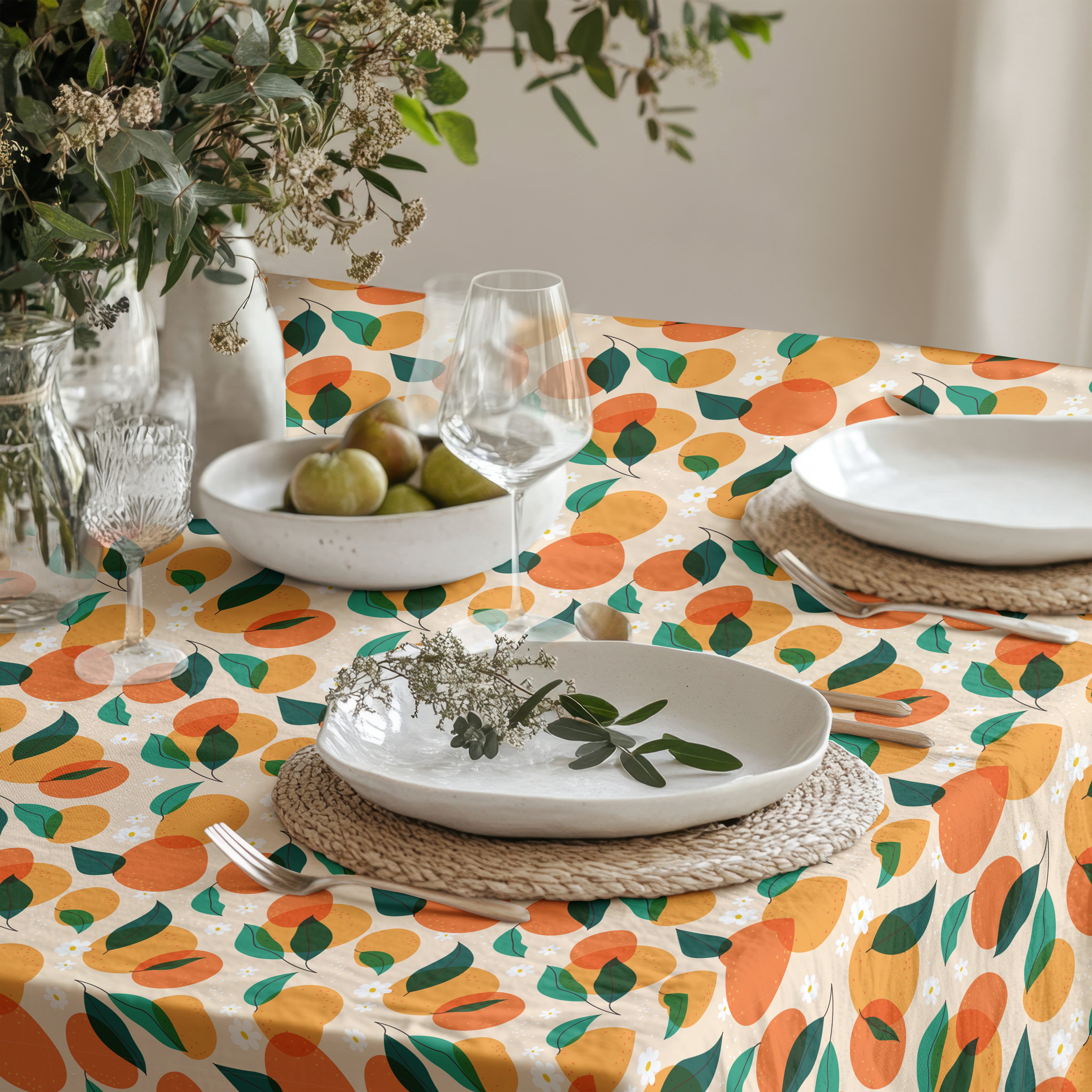 Colorful orange grove tablecloth featuring vibrant citrus fruit and green leaves on premium cotton twill fabric.