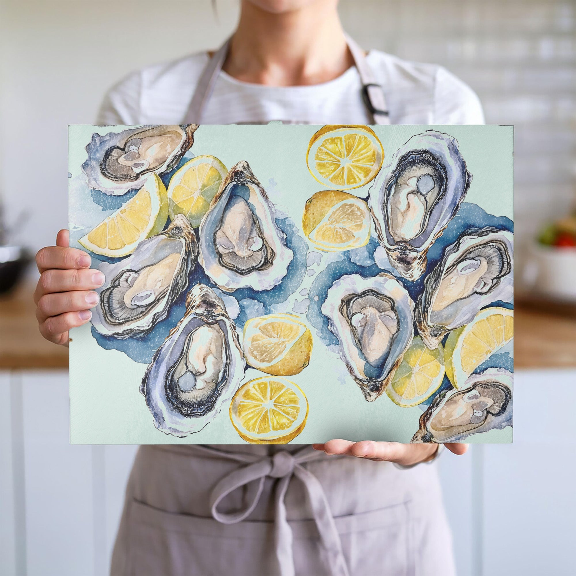 Coastal-inspired glass cutting board with hand-painted style oysters, lemons and soft seaside watercolor tones