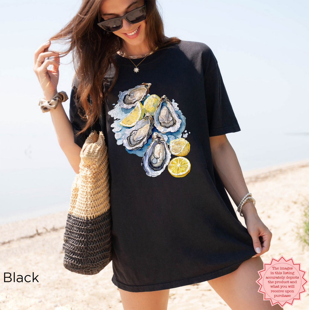 Black Comfort Colors T-shirt with vibrant watercolor oyster and lemon print, perfect for seafood lovers and coastal lifestyle outfits.