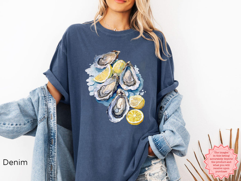 Denim blue Comfort Colors T-shirt with watercolor oyster design and lemons, styled for fisherman aesthetic and seaside casual wear.