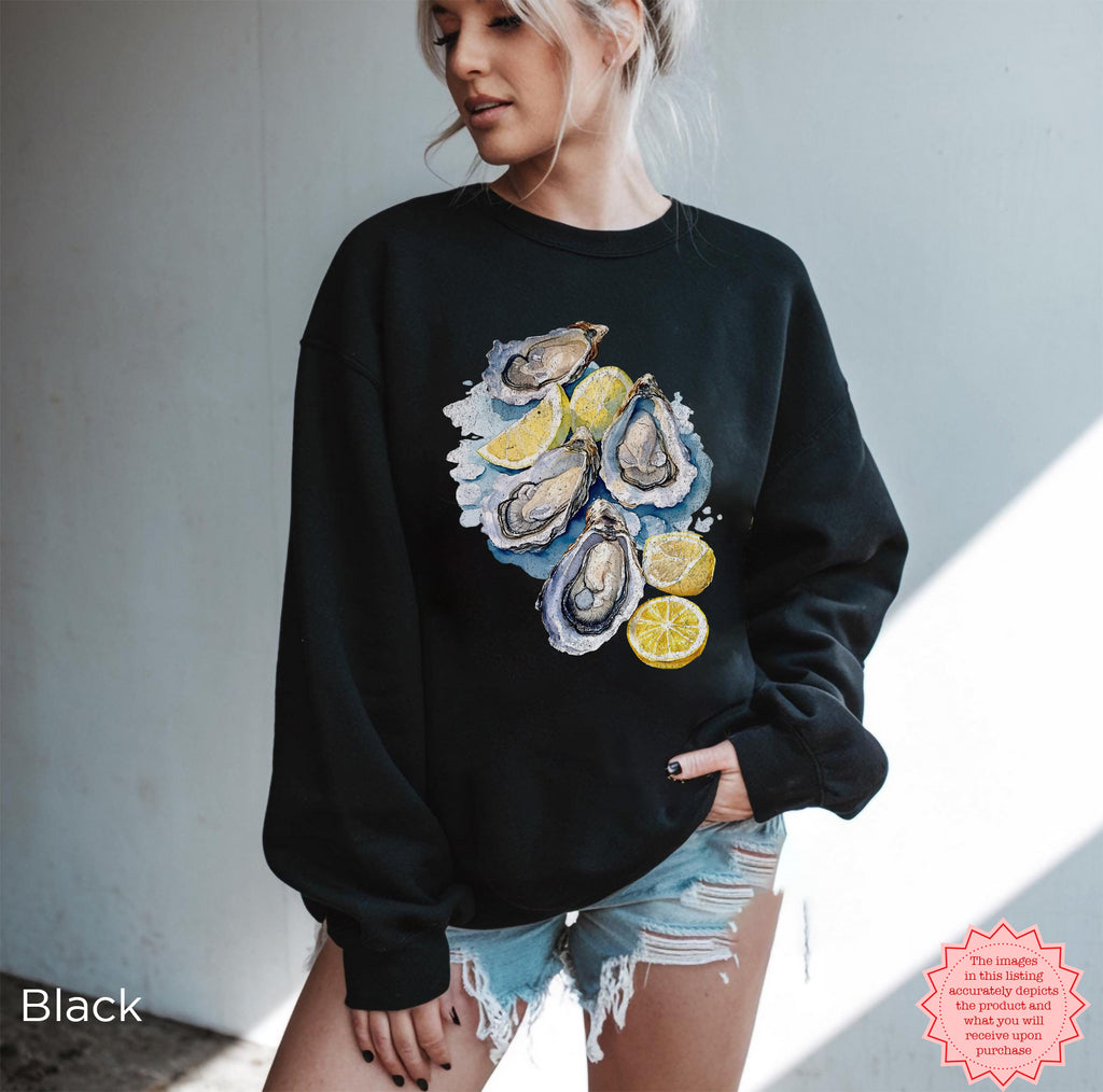 Black Oyster Shell sweatshirt featuring watercolor oysters and lemon slices, Gildan 18000 DTG pullover, trendy coastal and fisherman aesthetic, ideal for beach and marine life lovers.