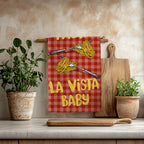 Pasta La Vista Baby cotton twill tea towel with two spaghetti forks and yellow lettering on a red gingham pattern