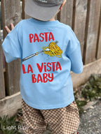 Child modelling the Pasta La Vista Baby kids' T-shirt, showcasing the colourful spaghetti graphic on the back.