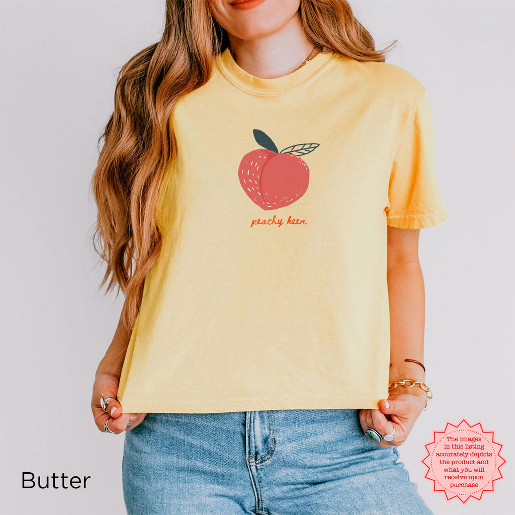Peachy Keen Crop Shirt in Butter Yellow with a playful peach graphic, perfect for warm summer days.