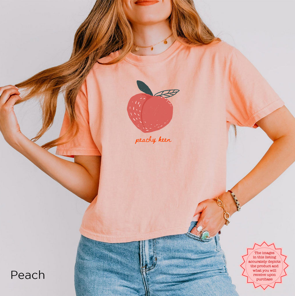 Peachy Keen Crop Shirt in Peachy Pink featuring a cute peach graphic and 'peachy keen' lettering, perfect for a fun summer vibe.