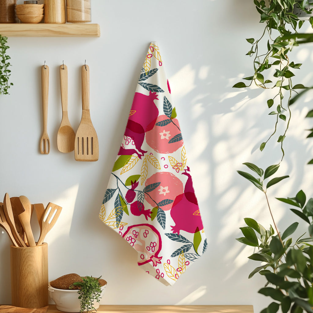 Colorful Mediterranean pomegranate tea towel hanging against white tiled kitchen wall