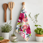 Pomegranate patterned kitchen towel featuring a hand painted style fruit design styled on a dining ta