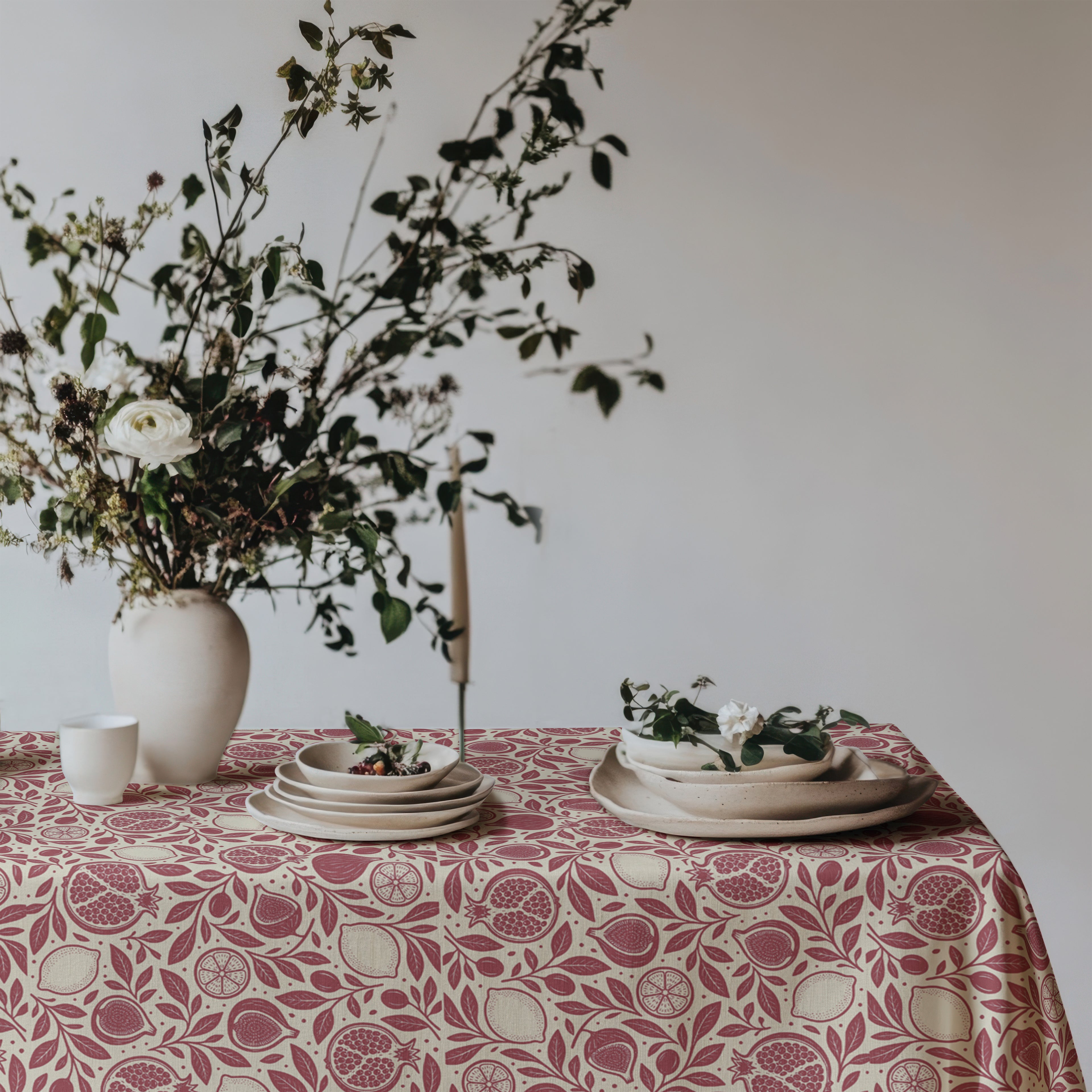 Red botanical tablecloth with pomegranates, figs, lemons and leafy branches on cream cotton twill