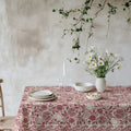 Red pomegranate, fig and lemon botanical cotton twill tablecloth on a dining table