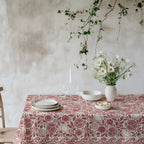Red pomegranate, fig and lemon botanical cotton twill tablecloth on a dining table