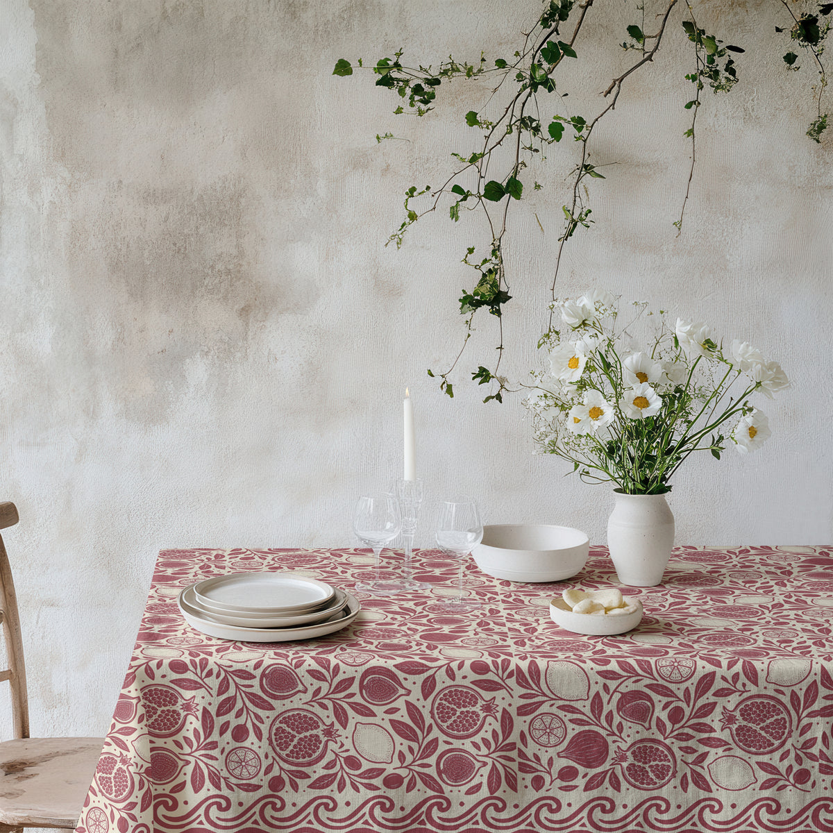 Red pomegranate, fig and lemon botanical cotton twill tablecloth on a dining table
