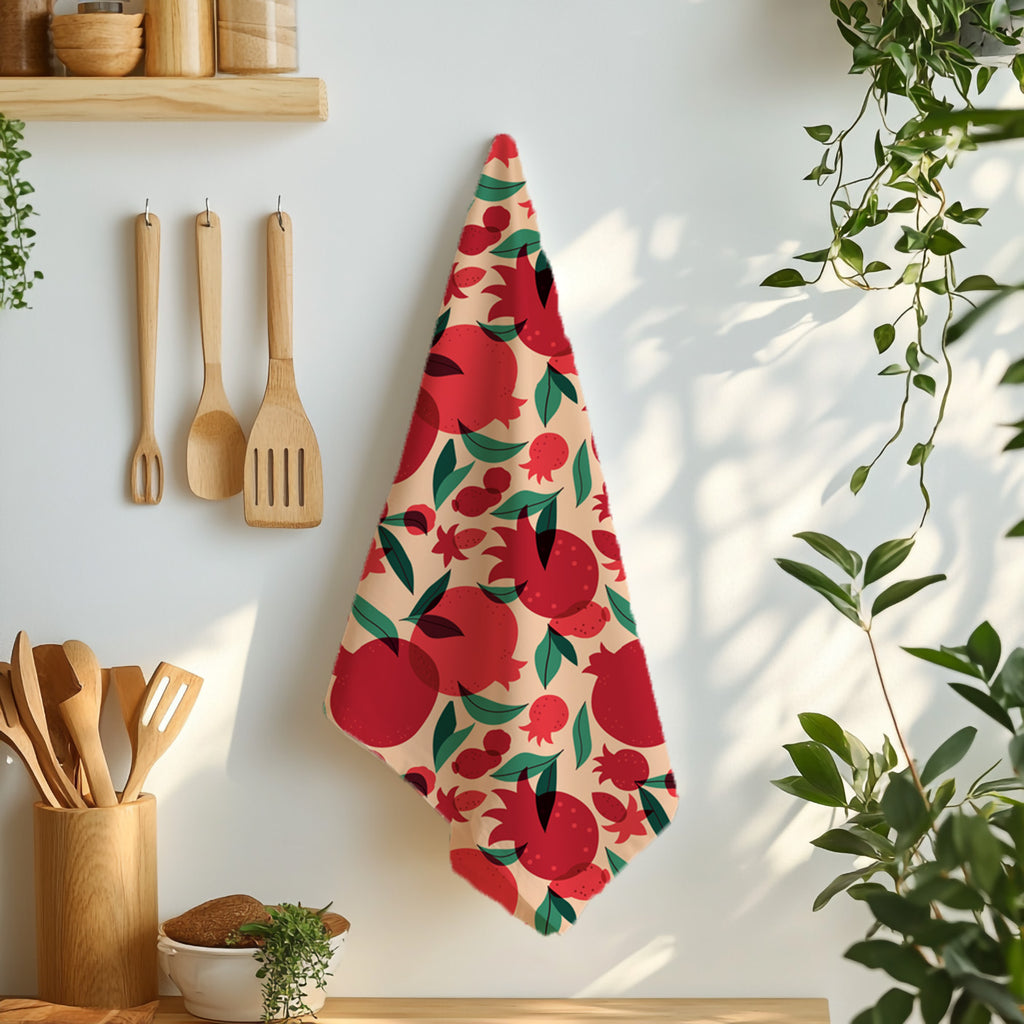 Mediterranean pomegranate tea towel featuring the That’s Amore design styled on a dining table with fork and knife