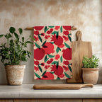 That’s Amore pomegranate tea towel hanging in a Mediterranean kitchen with wooden utensils and natural decor