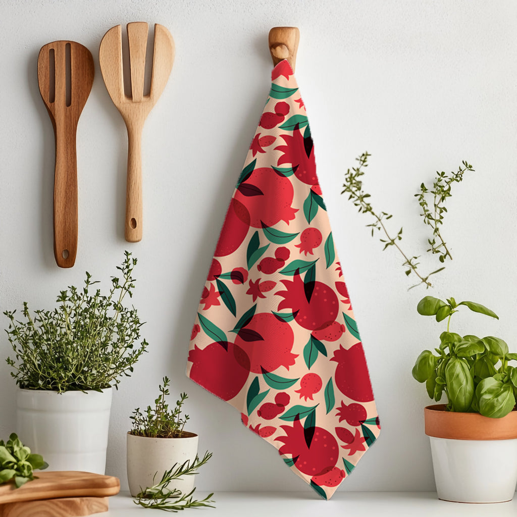 That’s Amore pomegranate tea towel displayed flat showing the full colorful Mediterranean fruit pattern