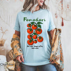 Colorful tomato vine graphic detail on Pomodori shirt showing DTG printed artwork on a soft garment-dyed cotton tee