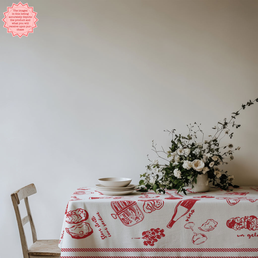 Bright red Italian food-themed tablecloth featuring drawings of Italian dishes, with wine glasses and minimalist table settings.