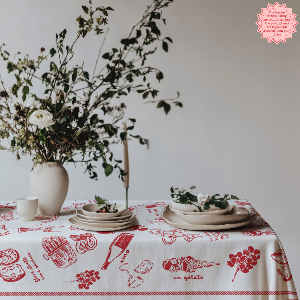 Red Italian food tablecloth featuring hand-drawn ice cream cones and pasta illustrations, paired with a vintage chair and floral decor on the table