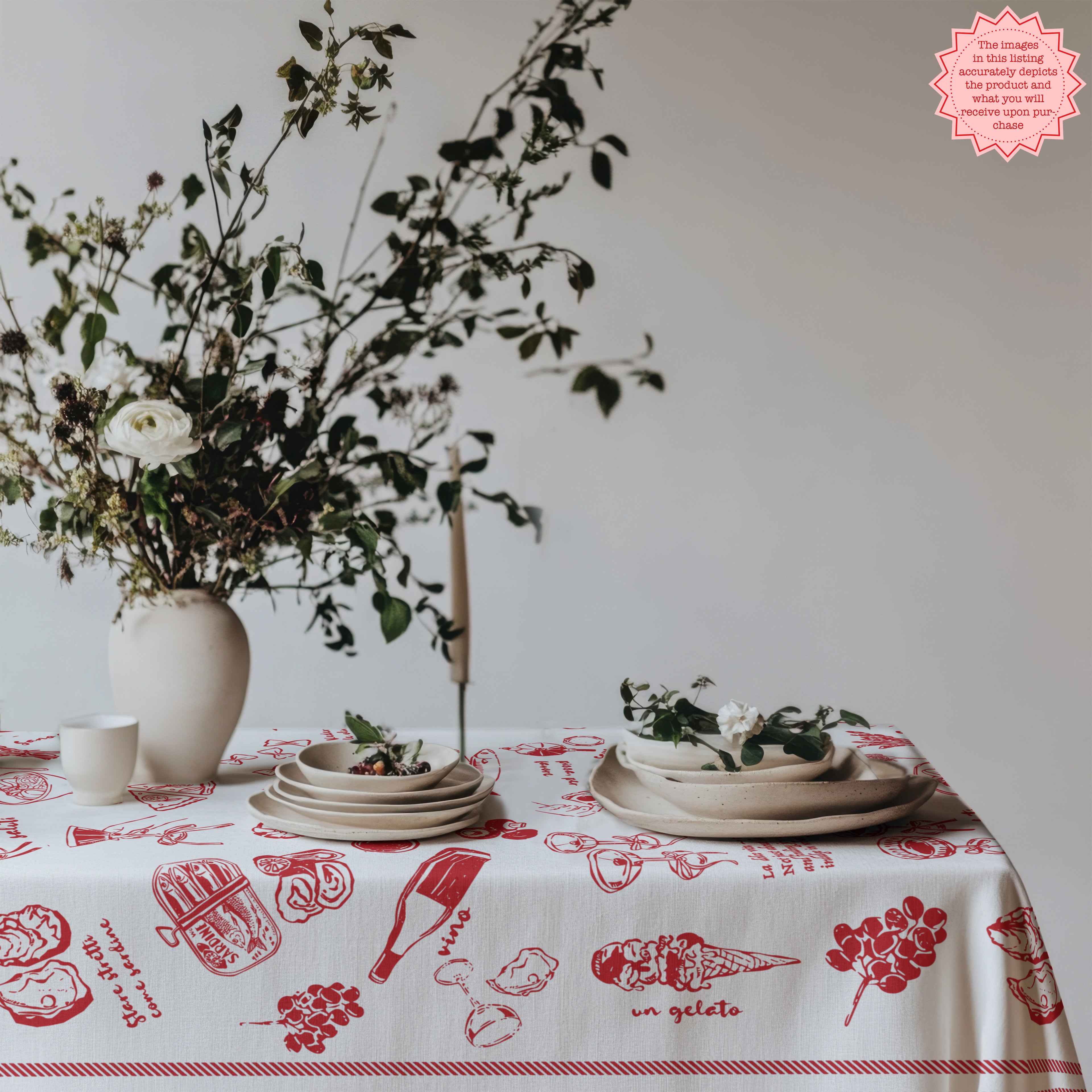 Red Italian food tablecloth featuring hand-drawn ice cream cones and pasta illustrations, paired with a vintage chair and floral decor on the table