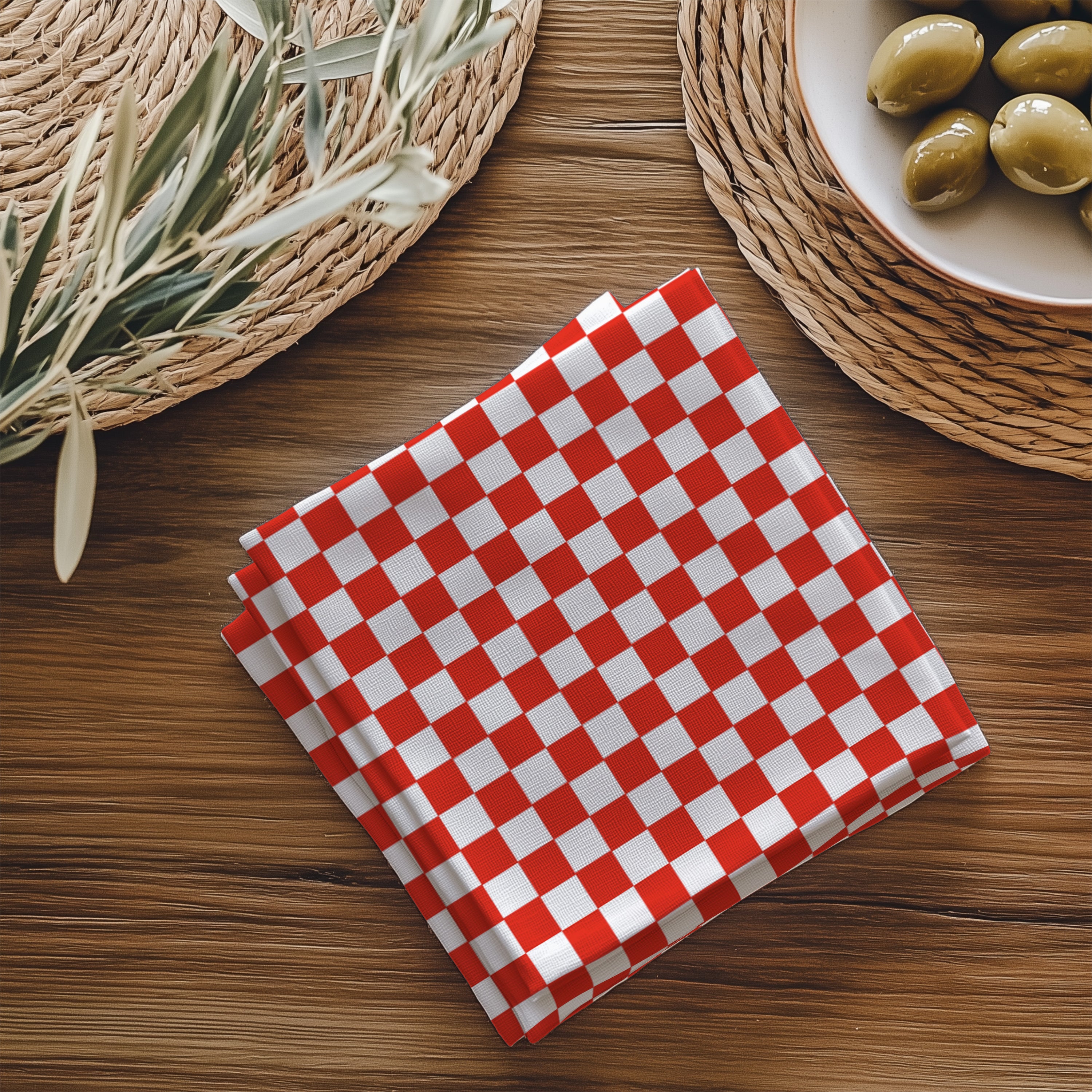 Close-up view of red gingham cotton napkin showing checker pattern detail and premium twill fabric texture