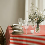 Red and white striped tablecloth styled with white crockery and glassware