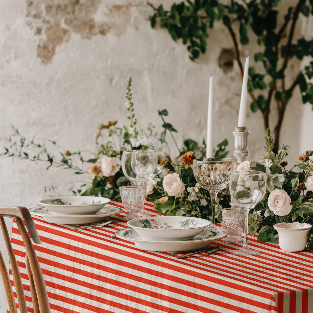 Red and white striped cotton tablecloth styled on a dining table