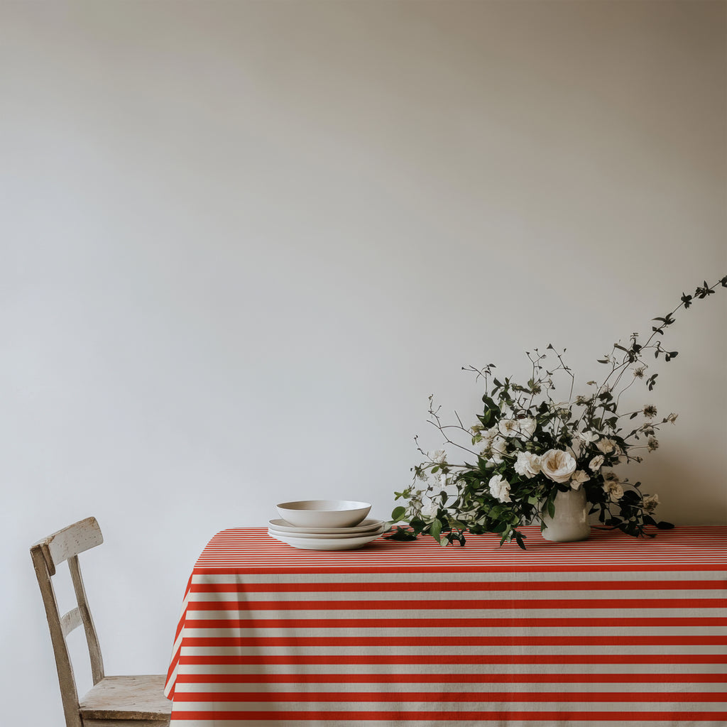 Red and white striped 100% cotton twill tablecloth styled for an elegant dining setting.