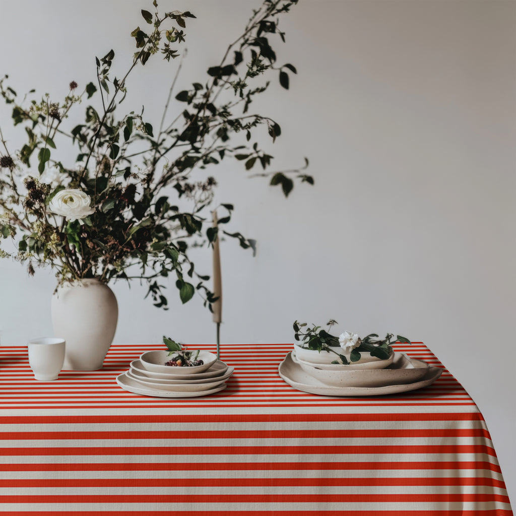 Classic red and white striped tablecloth paired with elegant tableware