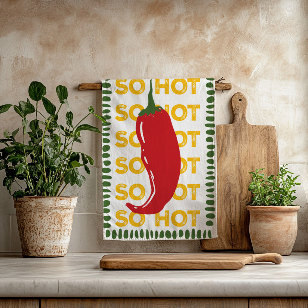 So Hot red chilli microfiber tea towel featuring a bold illustrated red chilli and playful typography on a white background.