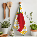Stylish red chilli tea towel hanging in a kitchen, perfect for lovers of spicy food and colourful home décor.