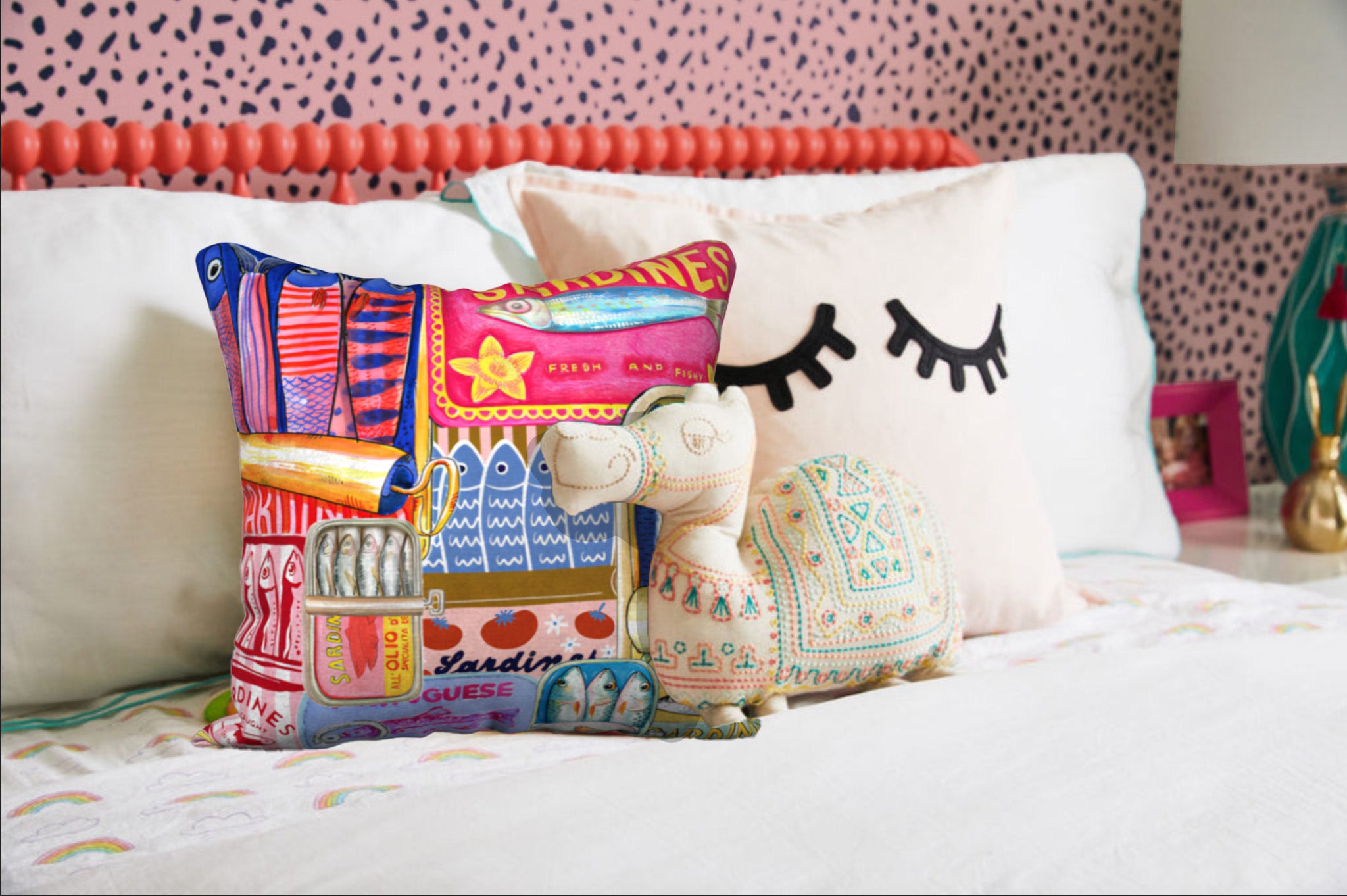 Sardines decorative cushion on a bed, showcasing the retro sardine can design in vibrant hues – available in 18x18 inches, with 4 fabric options.