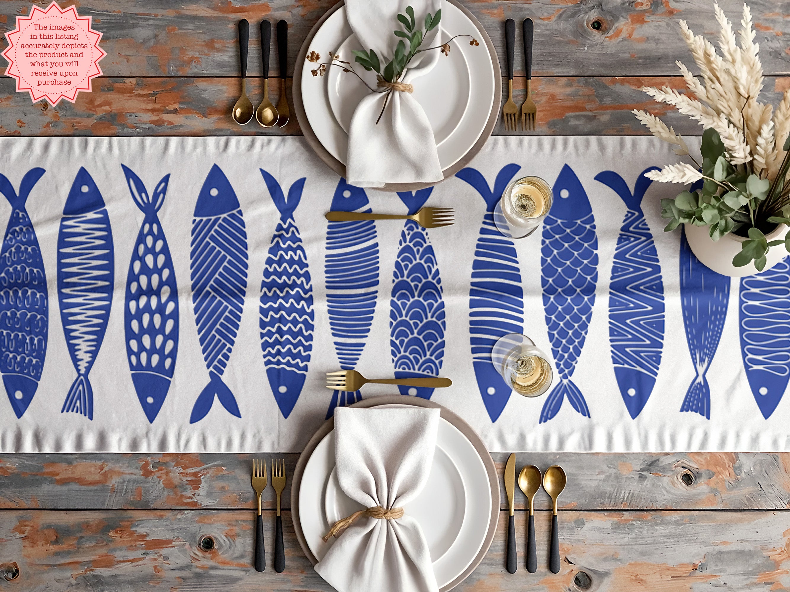 Blue cotton table runner with Scandinavian folk fish pattern, perfect for coastal-inspired dining decor.