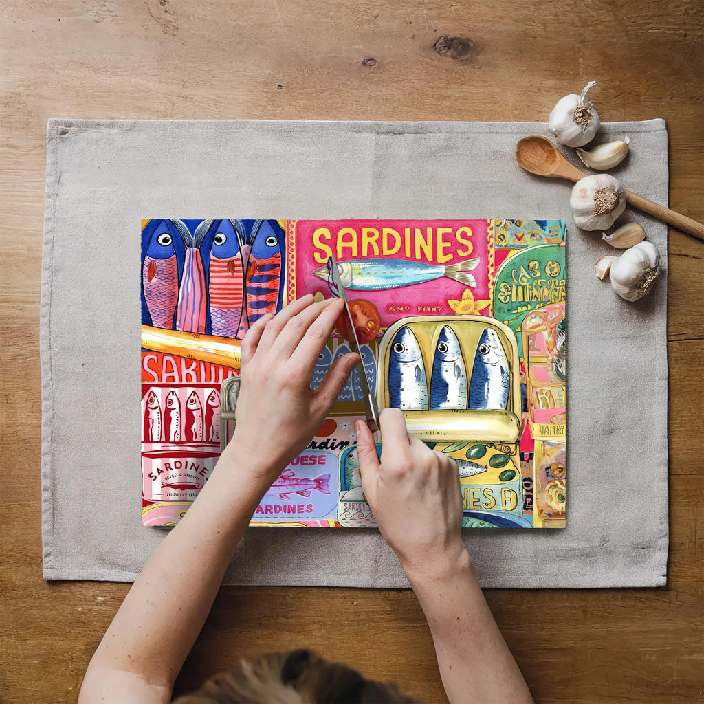 Colourful sardine collage artwork printed on a textured tempered glass cutting board