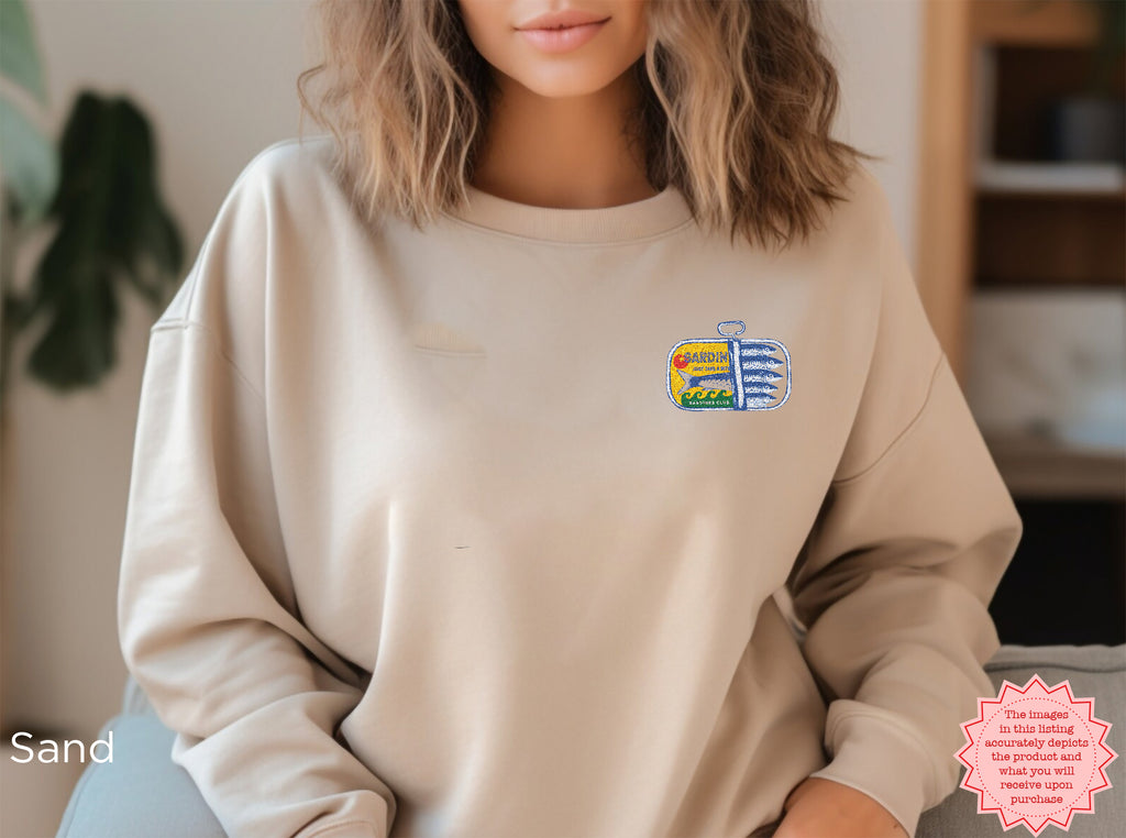 Sand colored sardines embroidered sweatshirt with embroidered canned fish artwork — soft, casual sweatshirt.