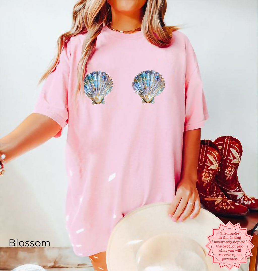 Trendy seashell graphic tee in pastel blossom, ideal for summer fashion.